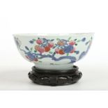 An 18th century Chinese famille rose bowl on associated hardwood stand. Painted in underglaze blue