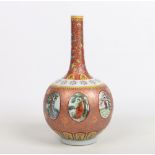 A 20th century Chinese bottle vase. Ground in an unusual copper glaze, enamelled with lotus