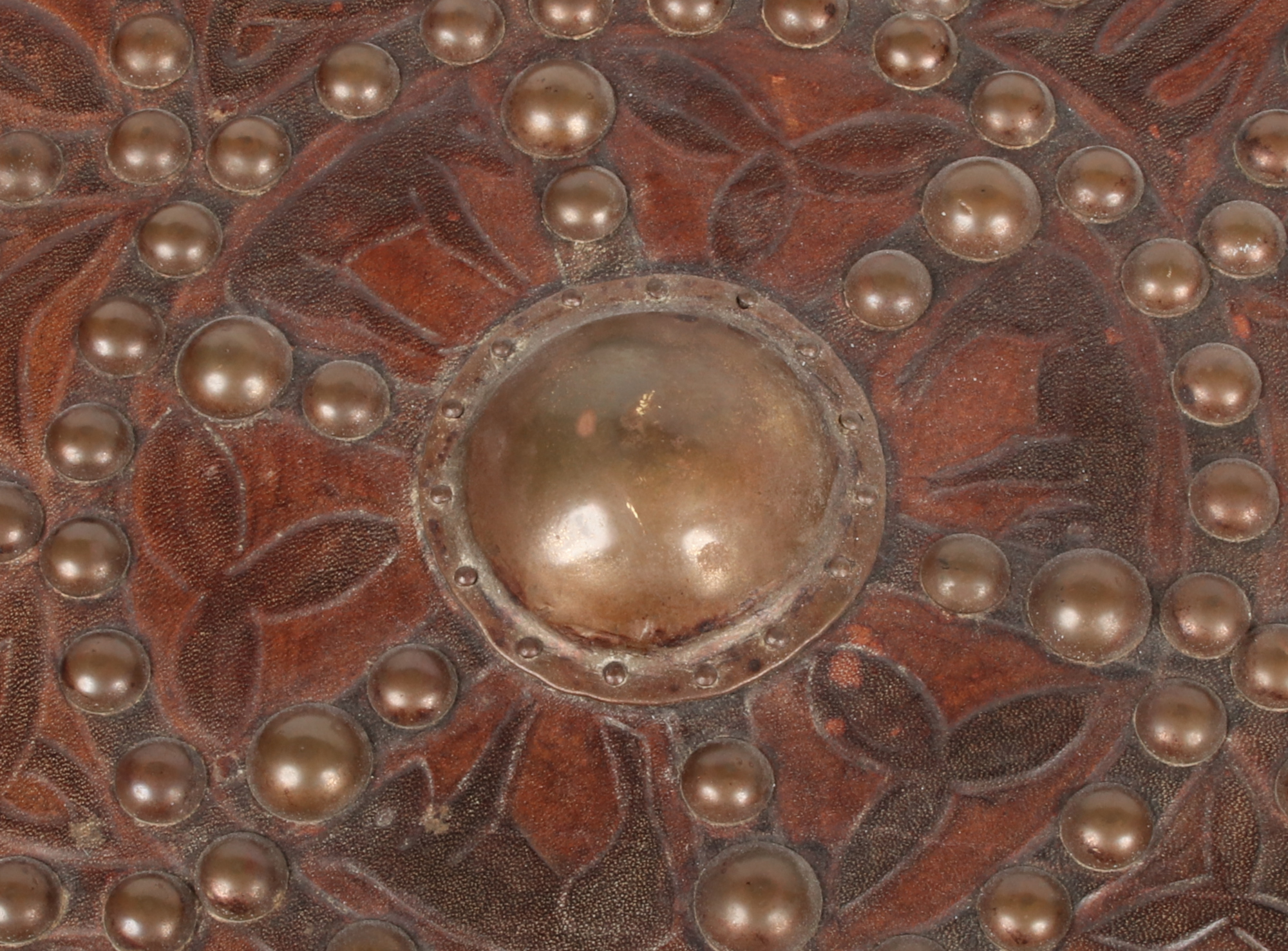 A decorative leather clad roundel shield adorned with brass studwork and tooled with animals and - Image 3 of 4