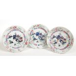 Three 18th century Chinese famille rose plates. Each painted with an island landscape under peony