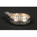 An early 20th century French silver wine taster by Marc Parrod. The thumb piece decorated with a