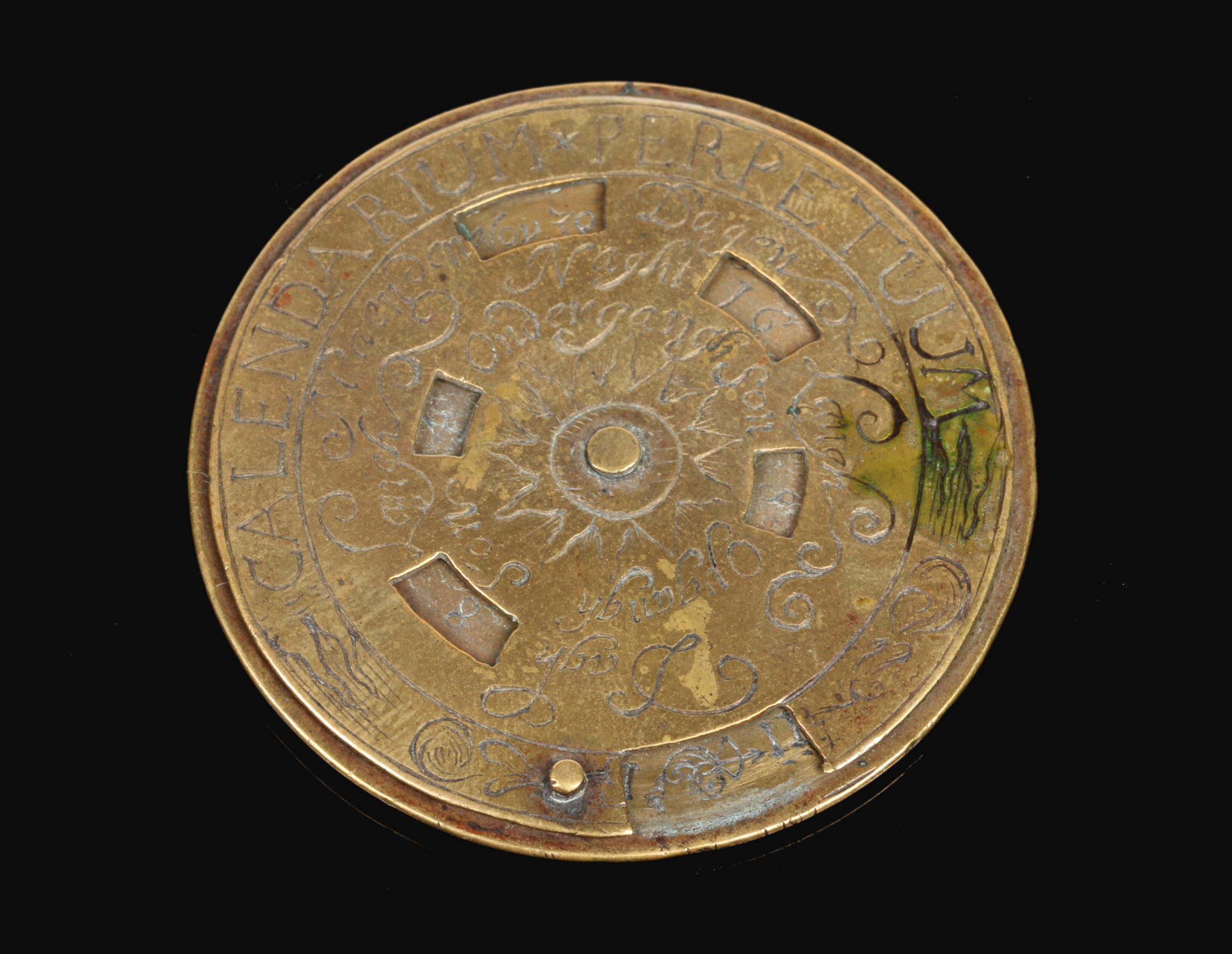 An 18th century Continental brass pocket perpetual disc calendar. Inscribed Calendarium Perpetuum