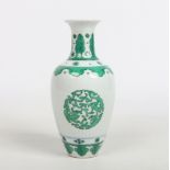 A small Chinese baluster shaped vase. Outlined in underglaze blue and painted in green enamel with