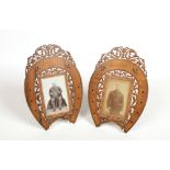 A pair of olive wood Sorrento ware picture frames of horseshoe form. Each with open fret pediments