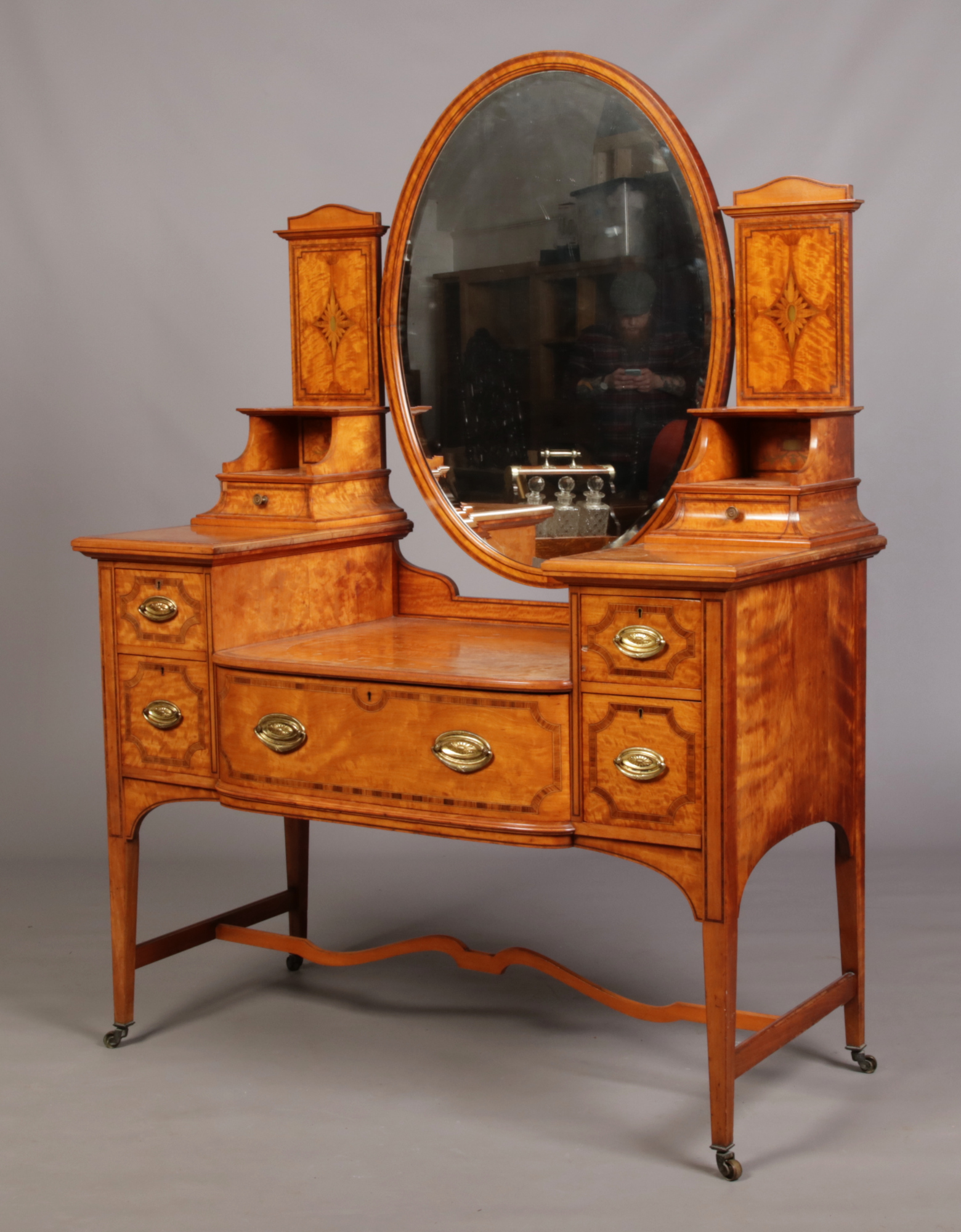 A Victorian Sheraton revival satinwood dressing table by James Shoolbred & Co. Crossbanded in