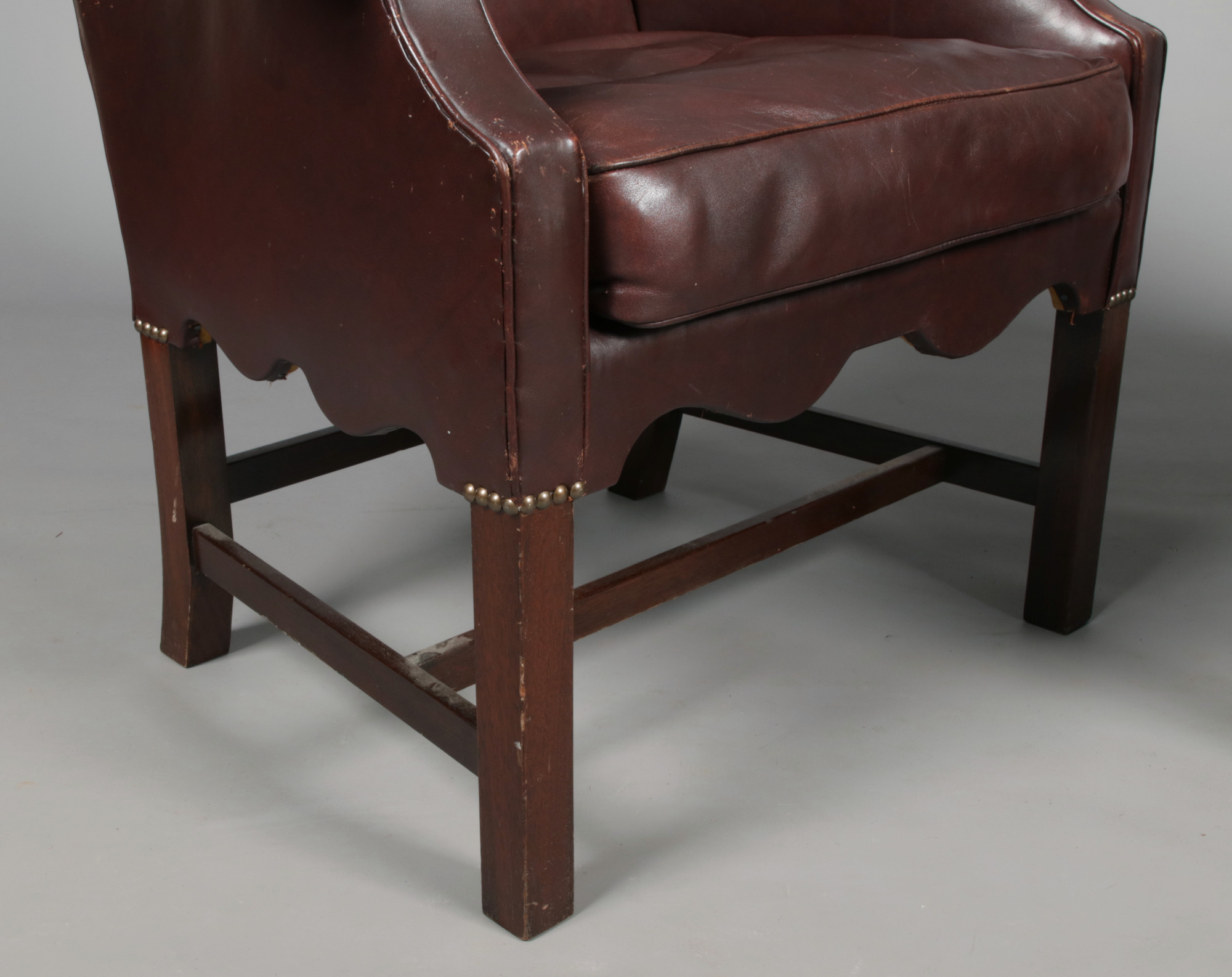 A pair of early 20th century leather upholstered camel back armchairs with brass studwork and raised - Image 2 of 3