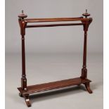 A Victorian inlaid mahogany towel rail. With reeded urn shaped finials and raised on square scroll