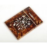 A Victorian tortoise shell card case inlaid with mother of pearl depicting flower sprigs, 10.5cm.