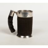 A Continental tankard with white metal mounts, hide covered and with horn handle. Punch marks to the