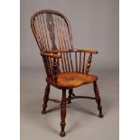 A 19th century ash and elm Windsor armchair. With pierced baluster shaped splat, crinoline stretcher