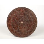 A decorative leather clad roundel shield adorned with brass studwork and tooled with animals and