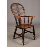 A 19th century ash and elm Windsor armchair in the manner of William Birch. With pierced centre