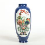 A 19th century Chinese Kangxi style powder blue ground vase. Painted within reserved panels in the