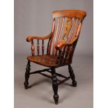 A Victorian ash and elm slat back kitchen armchair with pierced centre splat, 111cm.Condition report