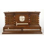 A 1920s carved oak breakfront snooker score board, with ivory markers and incorporating a Ferranti