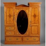 A fine quality Victorian Sheraton revival satinwood triple wardrobe with stepped pediment by James