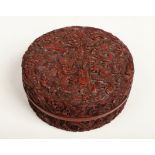 A 19th century Chinese cinnabar lacquer circular box and cover. Carved with nine fierce dragons