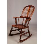 A Victorian pad arm Windsor rocking chair with turned cross stretcher.