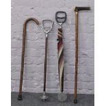 Two shooting sticks and two walking sticks one with antler handle.