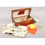 A mahogany box and contents of vintage first aid supplies including literature, the vernaid bandage,