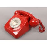 A vintage red GPO telephone.