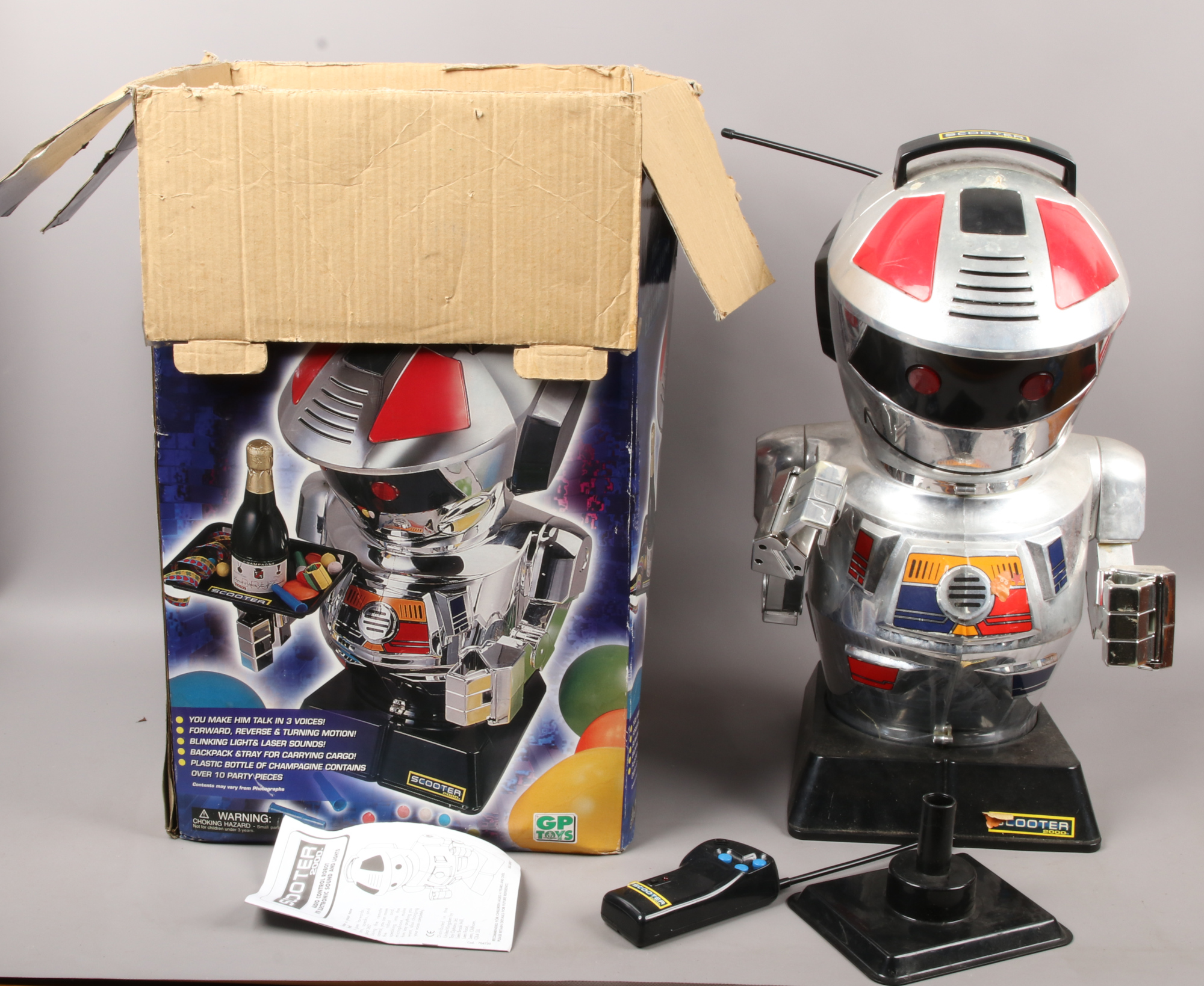 A boxed radio controlled scooter 2000 robot toy.