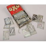 A vintage Oxo advertising tin and contents of various tin letter stencils.