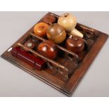 A pipe rack and collection of treen boxes one set with an Edward VII silver coin.