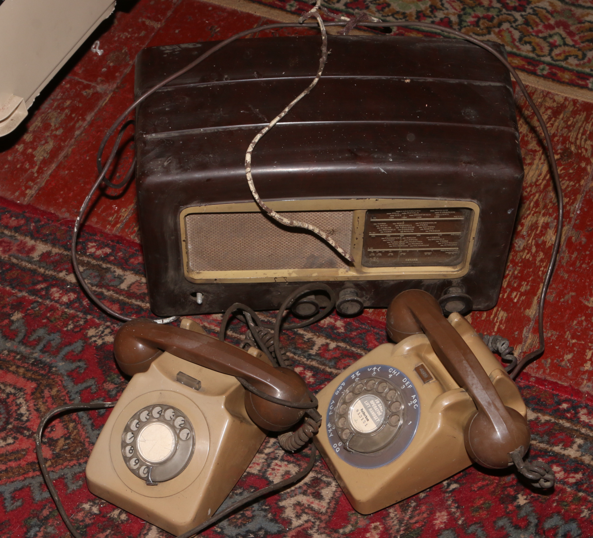 A vintage Cossor Melody maker radio for repair, along with two vintage Rotary dial telephones.