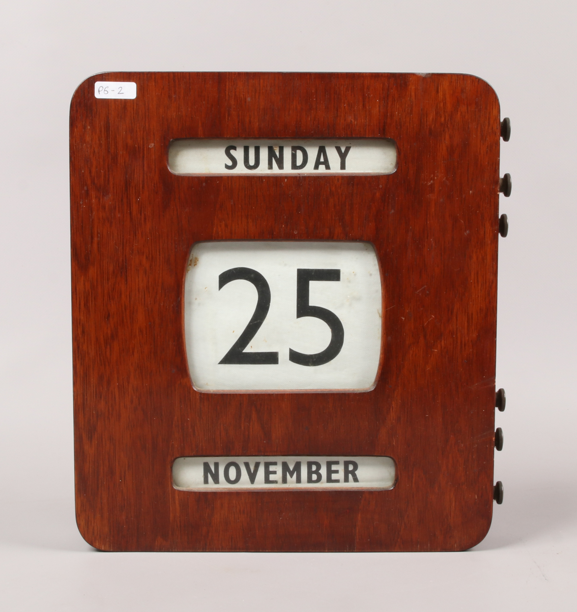 A mahogany cased 1940s wall mounted perpetual bank calendar, 30.5 x 27 x 5.5cm.Condition report