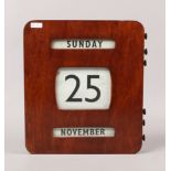 A mahogany cased 1940s wall mounted perpetual bank calendar, 30.5 x 27 x 5.5cm.Condition report