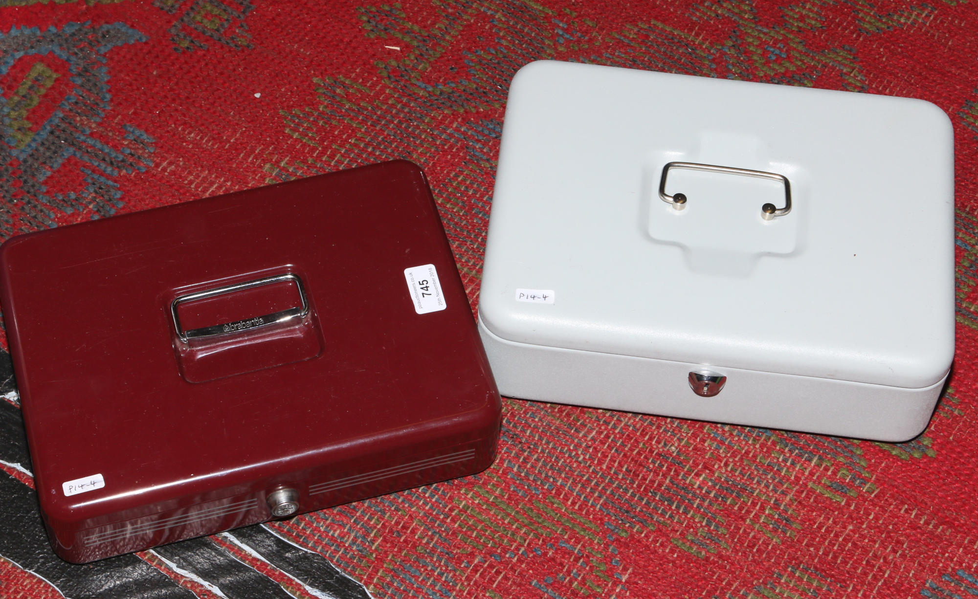 Two metal cash boxes with keys.