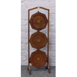 An early 20th century mahogany folding three tier cake stand.