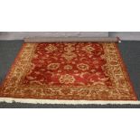 A red ground Ziegler rug with floral design, 230cm x 160cm.