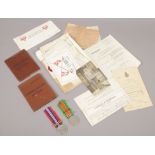 A collection of World War One and World War Two ephemera to include soldiers release book, discharge