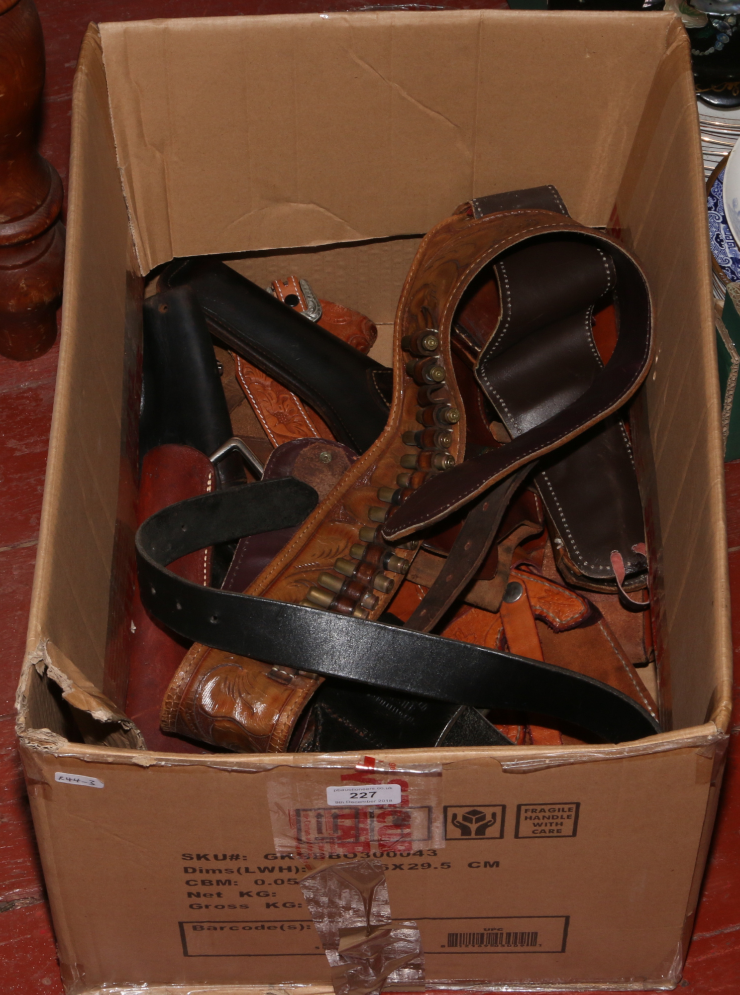 A box of good quality leather gun holsters to include belts, shoulder straps etc.