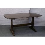 An Ercol refectory table. Height 72cm Width 86cm Length 153cm.