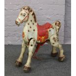 A vintage Mobo Bronco tin toy horse.