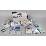 Four retro Nintendo gaming consoles, including a boxed Gameboy, a boxed Gameboy Advance and a