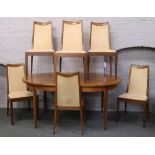 A G plan teak extending oval table with six matching dining chairs.