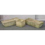 A pair of concrete planter troughs along with a square example.