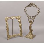 A brass Art Nouveau style figural mirror frame, along with a brass Art Nouveau style easel picture