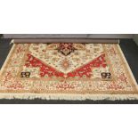 A beige ground Heriz rug with medallion design, 285cm x 200cm.