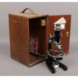 A cased microscope by J. Swift & Son London along with several lenses and other accessories.