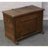 A panelled oak chest with wrought iron strap hinges, 78 x 41 x 57cm
