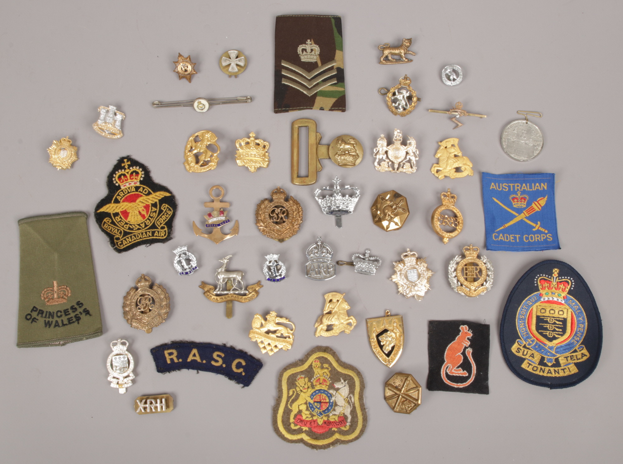 A collection of military badges to include A. R. P Royal Navy, Royal Engineers, Air Training Corps