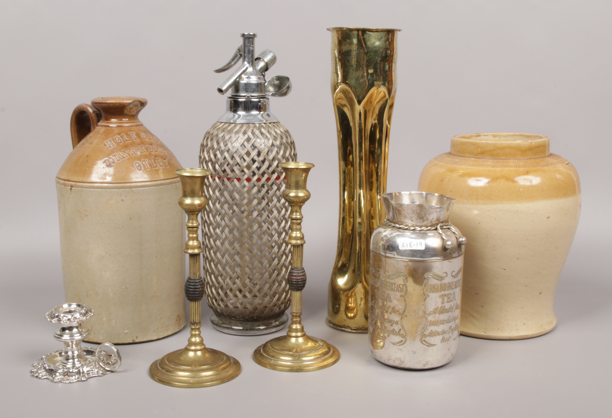 A group of mixed stoneware and metalware to include Flagon, trench art, English breakfast tea jar