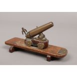 A 19th century working miniature brass canon adjustable for trajectory.