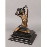 An erotic bronze sculpture of a semi nude maiden raised on a hardwood plinth.