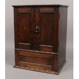 An early 20th century carved and panelled oak smokers cabinet, height 47cm, width 35.5cm, depth 29.